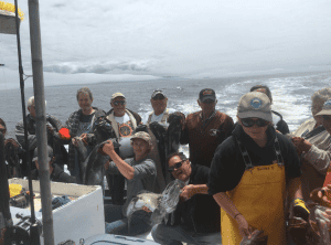 Group of people enjoying deep sea fishing trip