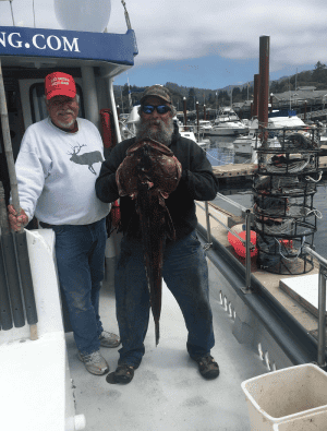 Two fishermen holding a large octopus at marina