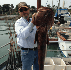 Man holding large fish at the marina