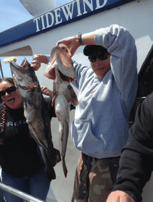 Fishermen with catch in front of Tidewind boat