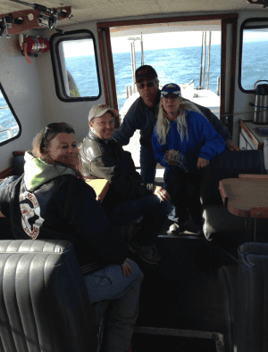 Group of friends enjoying a boat ride at sea