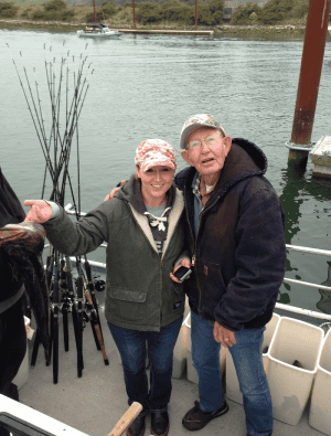 Two happy anglers standing on a fishing boat